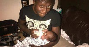 Terry G feeding his son