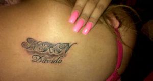 A Female Fan Tattoos Davido's Name on Her Back
