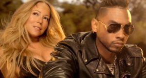 Mariah on the back of motorbike with singer Miguel