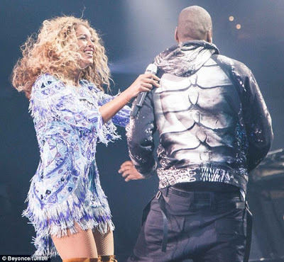 Jayz sneaks up behind a surprised Beyonce