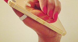 Genevieve Nnaji flaunts her gold plated iPhone5