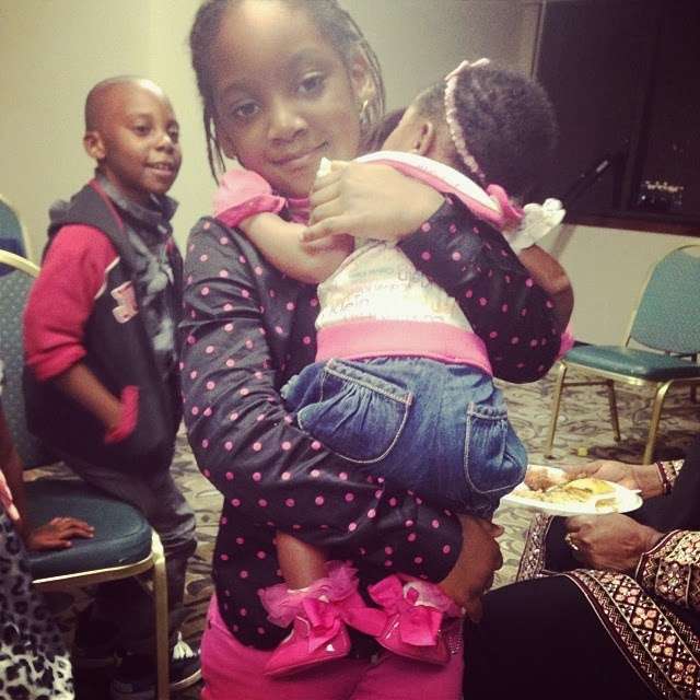 Isabella Idibia carrying her sister Olivia