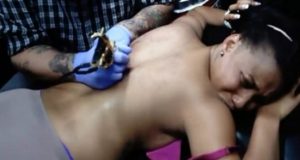 Tonto Dikeh shares photos of herself getting her massive back tattoo