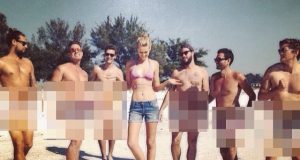 Toni Garrn poses with six n*de men