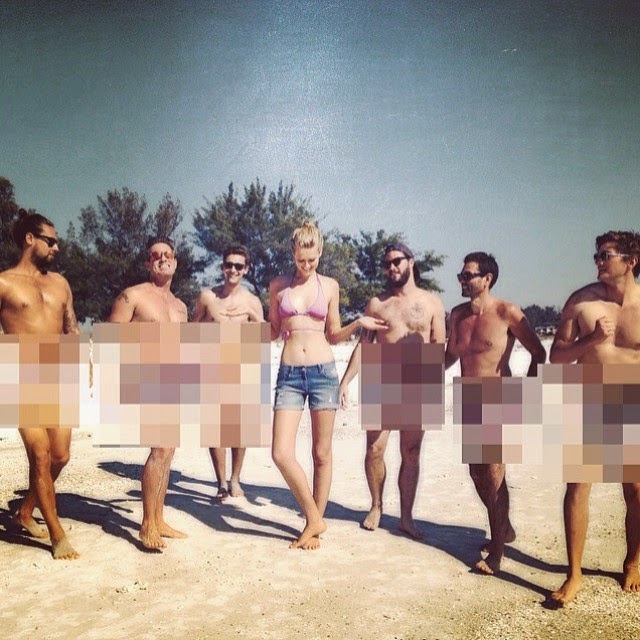 Toni Garrn poses with six n*de men