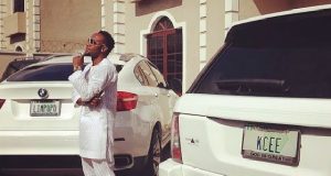 KCee poses next to his state of the art cars