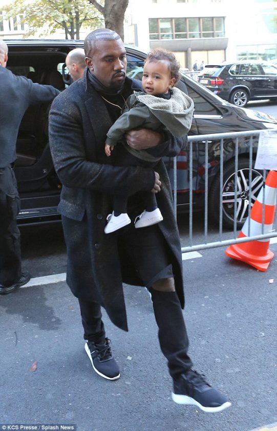 North West all smiles as daddy Kanye holds her