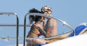 Rihanna spotted getting cosy with a topless female