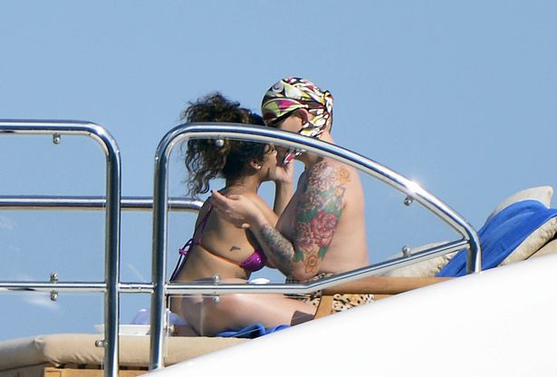 Rihanna spotted getting cosy with a topless female