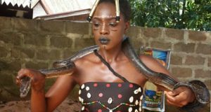 Beverly Osu cuddles a live snake