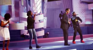 Chris Oyakhilome and daughter perform on stage