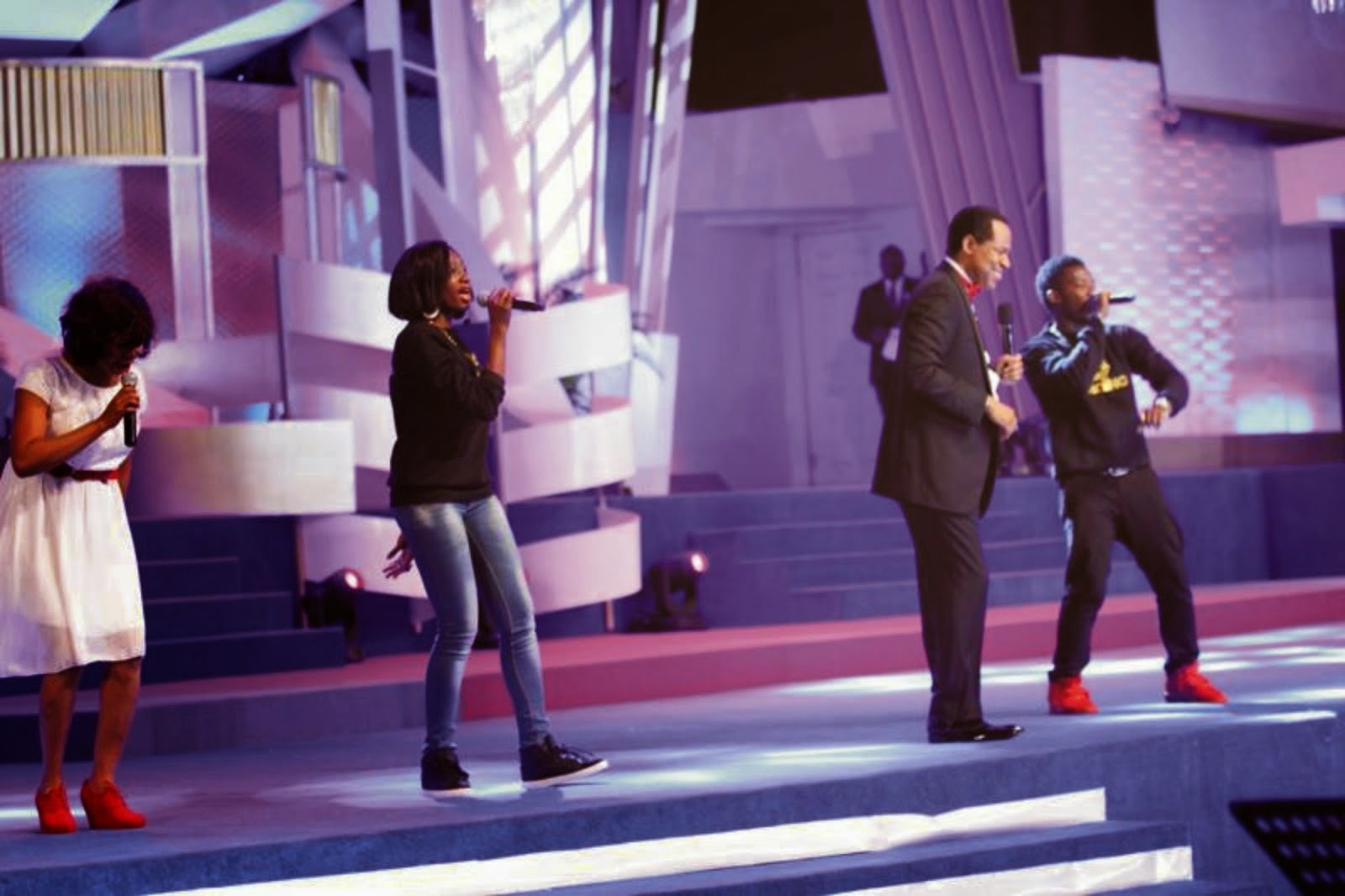 Chris Oyakhilome and daughter perform on stage