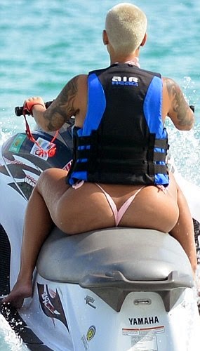 Amber Rose riding at the beach
