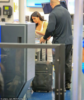 Kim K asked to take heels off through International Airport NaijaVibe