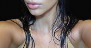 Kim K flaunts massive boobs on the cover of her selfie book