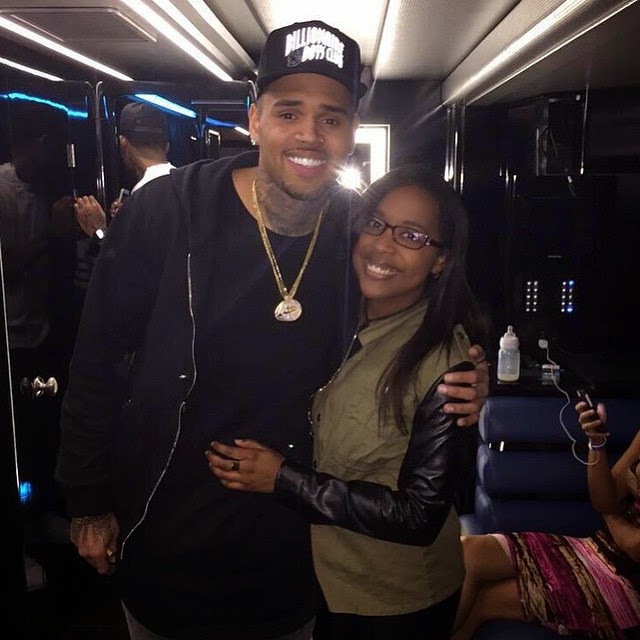 Chris Brown poses with baby Royalty's feeding bottle