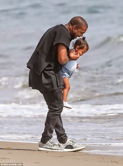 Kanye West and North at the beach