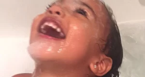 North West laughing in bath tub