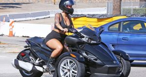 Amber Rose displays sexy curves as she rides sports bike