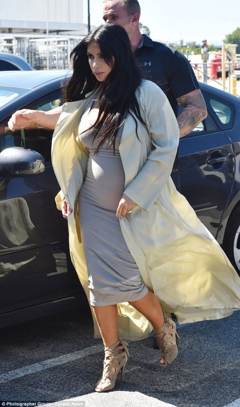 Kim Kardashian puts her growing baby bump on display